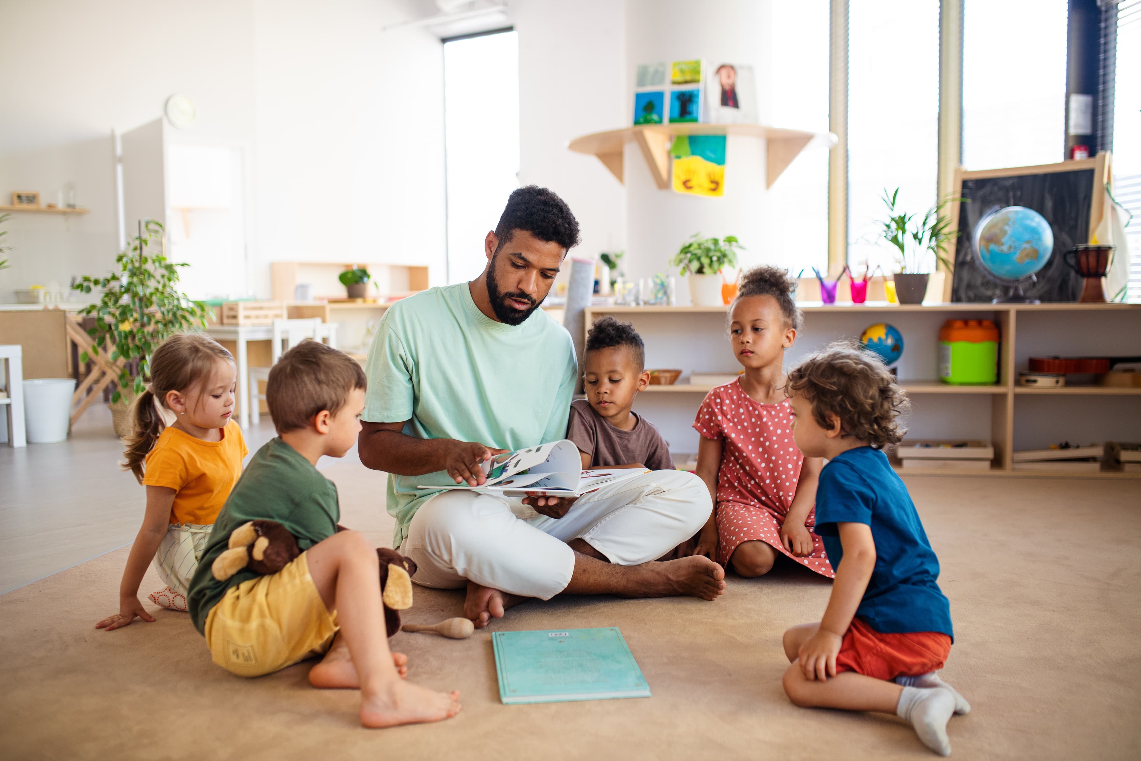 Pre-K children listening to a teacher during classroom story time